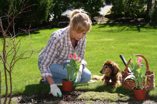 Worker using protective equipment during landscaping tasks